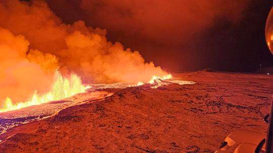 The eruption of a volcano on the Reykjanes peninsula of south-west Iceland is viewed in this webcam image.