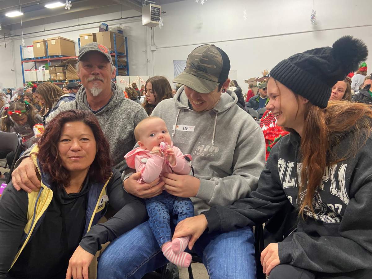 Three generations of the McManus family attend the annual elf rally for the Magic of Christmas.  They've been volunteering for four years. 