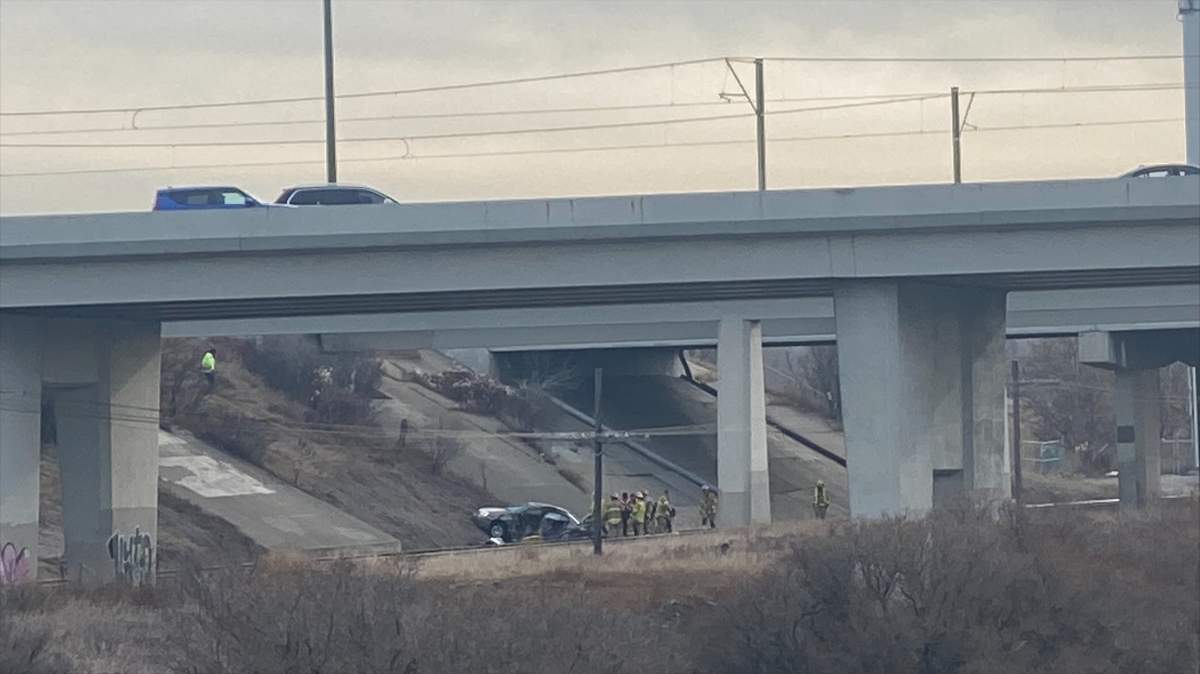 A vehicle is seen at the bottom of an embankment in Calgary midday on Dec. 1, 2023.