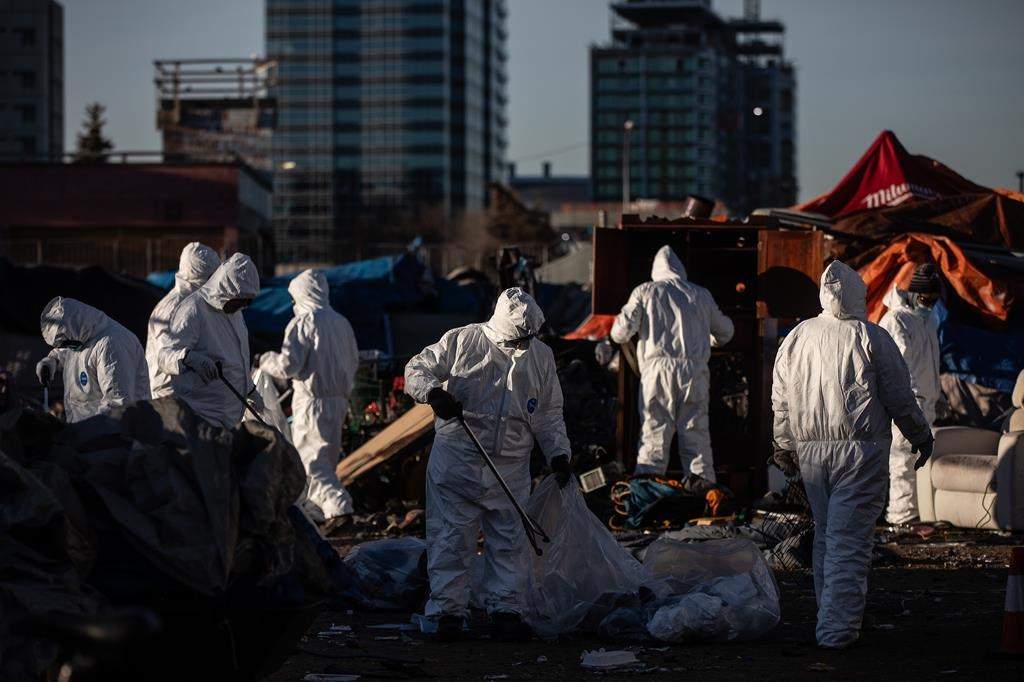 Cleanup crews tear down homeless encampments in Edmonton on Friday, Dec. 29, 2023.