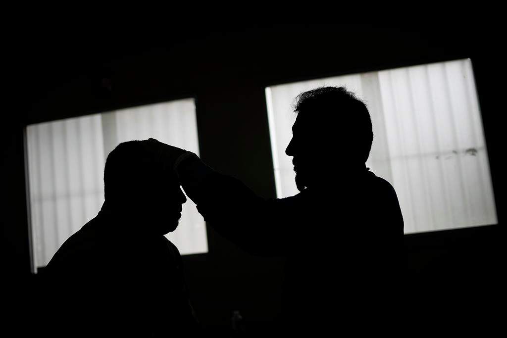 Montreal public health is urging clients of a man offering acupuncture treatments in the city's Notre-Dame-de-Grace neighbourhood to get tested for hepatitis B, hepatitis C and HIV. A doctor performs acupuncture therapy on a recovering COVID-19 patient at a government run health centre in the Coche neighbourhood of Caracas, Venezuela, Thursday, Feb. 25, 2021. THE CANADIAN PRESS/AP-Matias Delacroix.