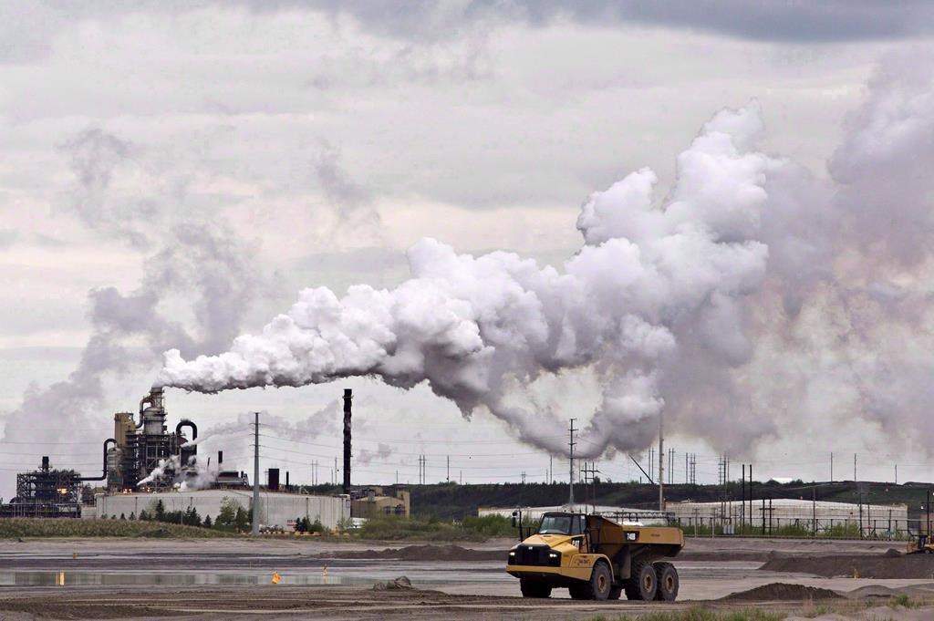 A dump truck works near the Syncrude oilsands extraction facility near the city of Fort McMurray, Alta., on June 1, 2014. 