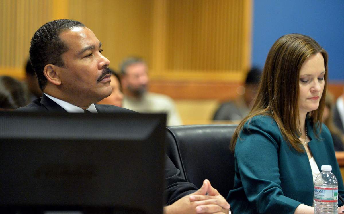 Dexter Scott King sits with the estate's attorney Nicole Wade during a hearing over who owns the Rev. Martin Luther King Jr.'s 1964 Nobel Peace Prize medal and traveling Bible on Tuesday, Jan. 13, 2015 in Fulton County Superior Court in Atlanta. King's estate, which is controlled by his sons, last year asked a judge to order King's daughter to surrender the items. In a board of directors meeting, Martin Luther King III and Dexter Scott King voted 2-1 against Bernice King to sell the two artifacts to a private buyer.