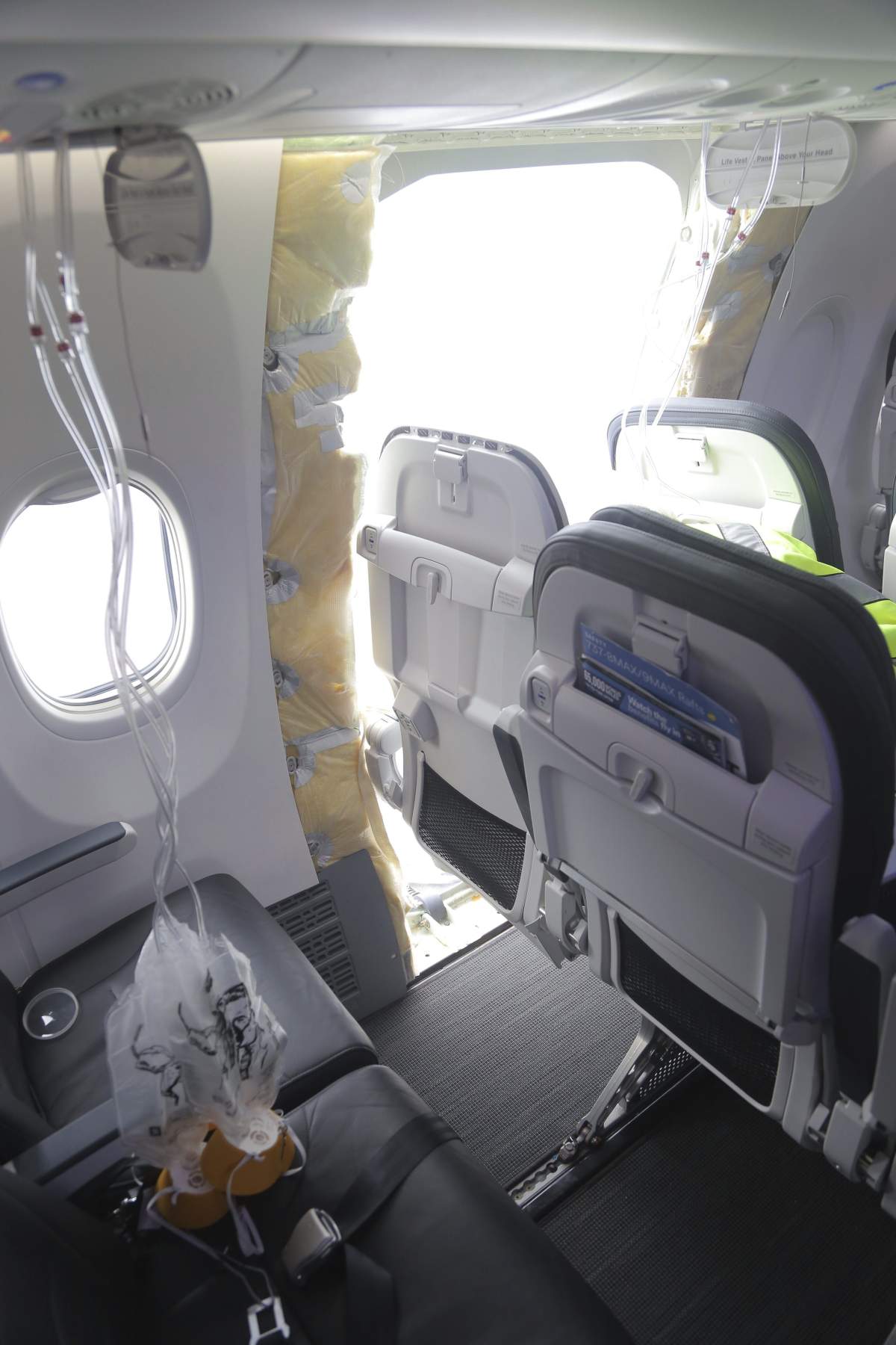 A gaping hole where the paneled-over door had been on Alaska Airlines Flight 1282.