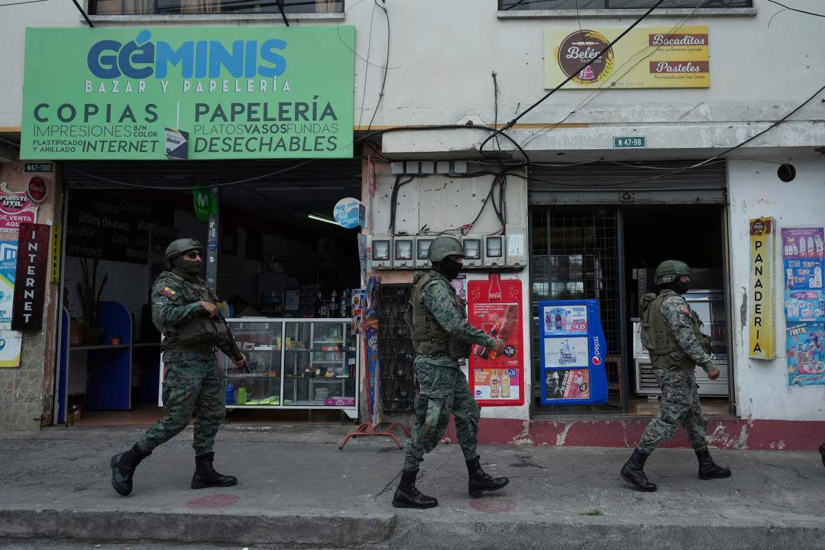 Soldiers patrol the perimeter of Inca prison during a state of emergency in Quito, Ecuador, Tuesday, Jan. 9, 2024, in the wake of the apparent escape of a powerful gang leader from prison. President Daniel Noboa decreed Monday a national state of emergency, a measure that lets authorities suspend people’s rights and mobilize the military in places like the prisons. The government also imposed a curfew from 11 p.m. to 5 a.m. (AP Photo/Dolores Ochoa)