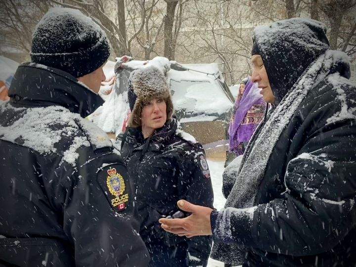 Edmonton police officers and city crews could be seen at a homeless encampment in the area of 95th Street and Rowland Road on Tuesday morning.