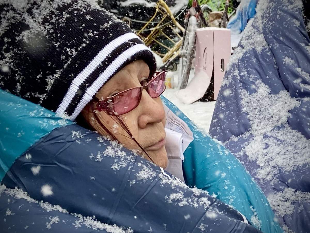 People tried to keep warm at an Edmonton homeless encampment in the area of 95th Street and Rowland Road on Tuesday morning.