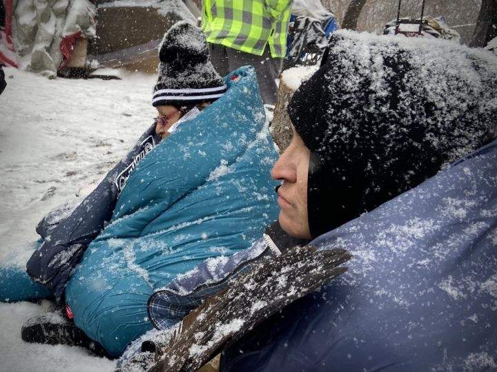 People tried to keep warm at an Edmonton homeless encampment in the area of 95th Street and Rowland Road on Tuesday morning.