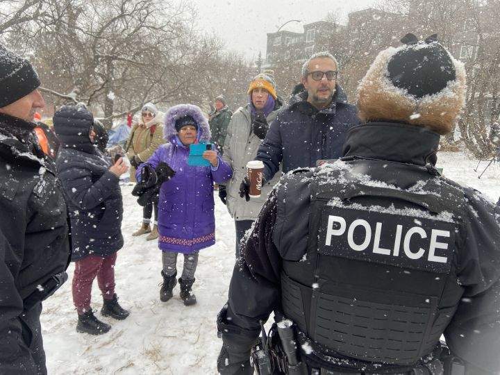 Edmonton police officers and city crews could be seen at a homeless encampment in the area of 95th Street and Rowland Road on Tuesday morning. Police and cleanup crews were met with resistance from people who live in the camp and from advocates who showed up to support them.