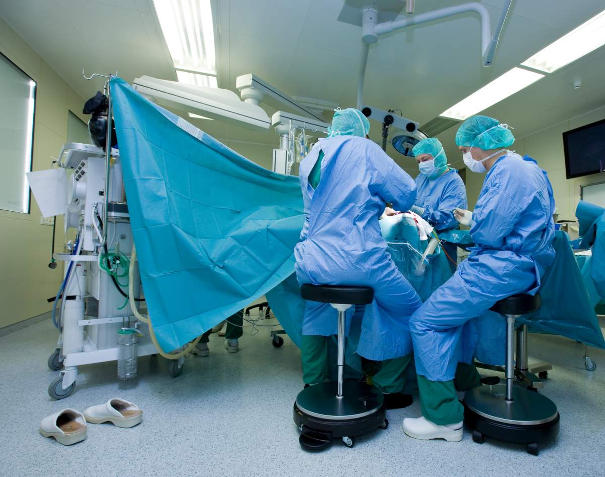 File photo of a team of surgeons operating to remove a brain tumour. A man in Florida was asked by his surgeons to play guitar during an awake craniotomy to remove a brain tumour.