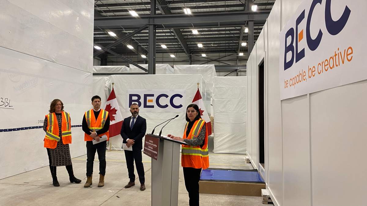 MP Filomena Tassi reveals a sample of a modular home on location at BECC Modular’s warehouse in the Ancaster Business Park on Jan. 15, 2024.