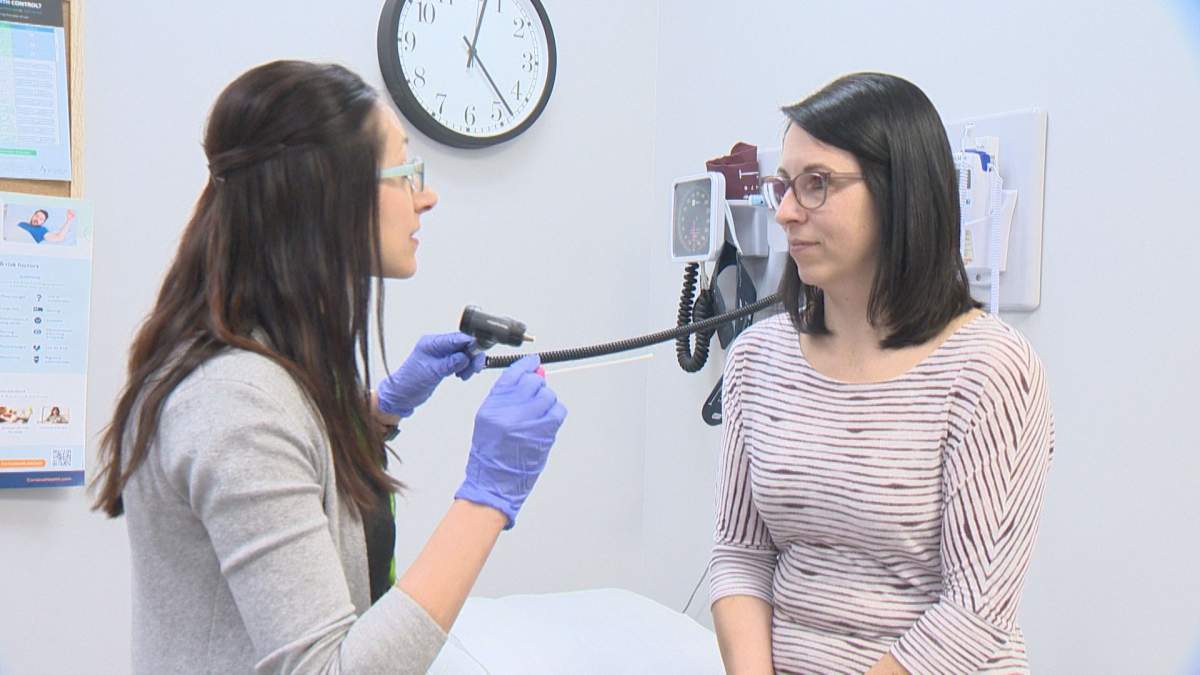 Joelynne Radbourne (left) helps a patient at the her clinic Vaida Health in Emerald Park.