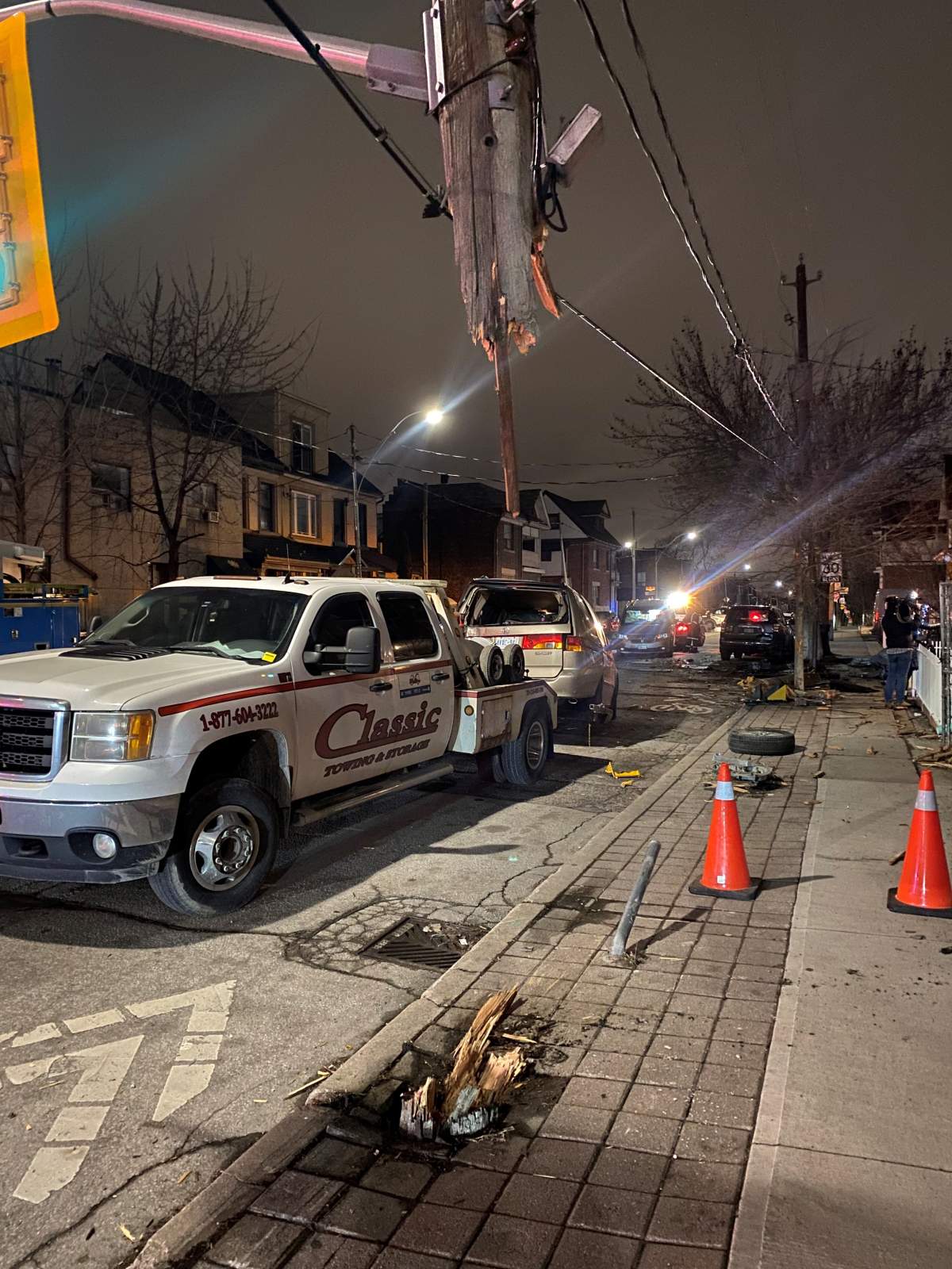 Vehicle being towed and a hydro pole severely damaged after crash in Toronto on Jan 30, 2024.