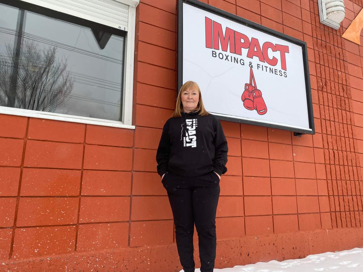 Dianna Raposo in front of Impact Boxing & Fitness