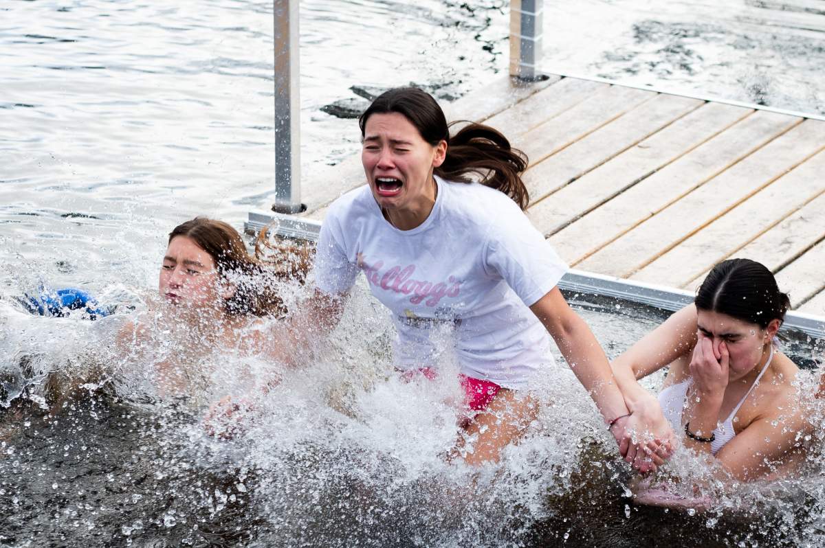 A Polar Bear plunger reacts as they jump into the Tay River to ring in the New Year on the 30th Anniversary of the Perth Polar Bear Plunge in Perth, Ont. on Monday, Jan. 1, 2024.