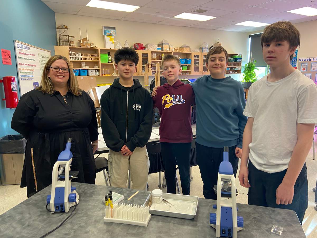 Grade 8 students at Michael Strembitsky School pose with their teacher.