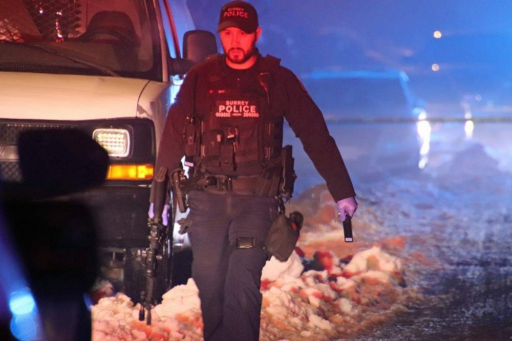 A Surrey RCMP officers seen at the shooting site, early Saturday.