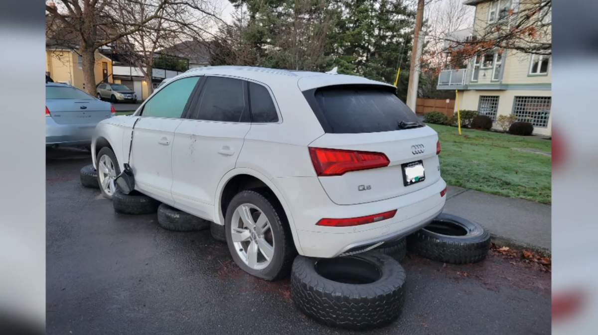 A photo of one of the damaged vehicles in Saanich, where it appears a mirror has been damaged and its tires flattened.