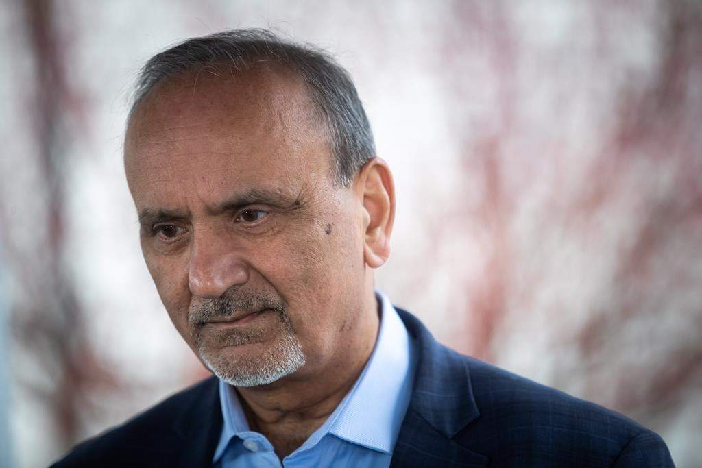 B.C. Labour Minister Harry Bains listens to a question in Surrey, B.C., on Monday, March 14, 2022.