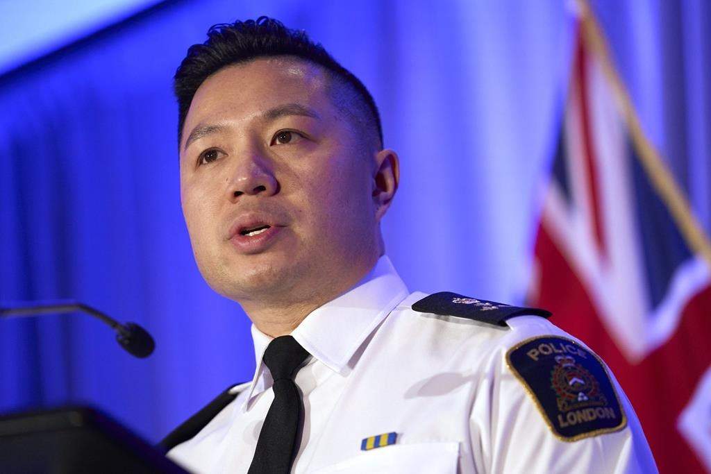 A closeup of a police chief speaking in front of a flag.