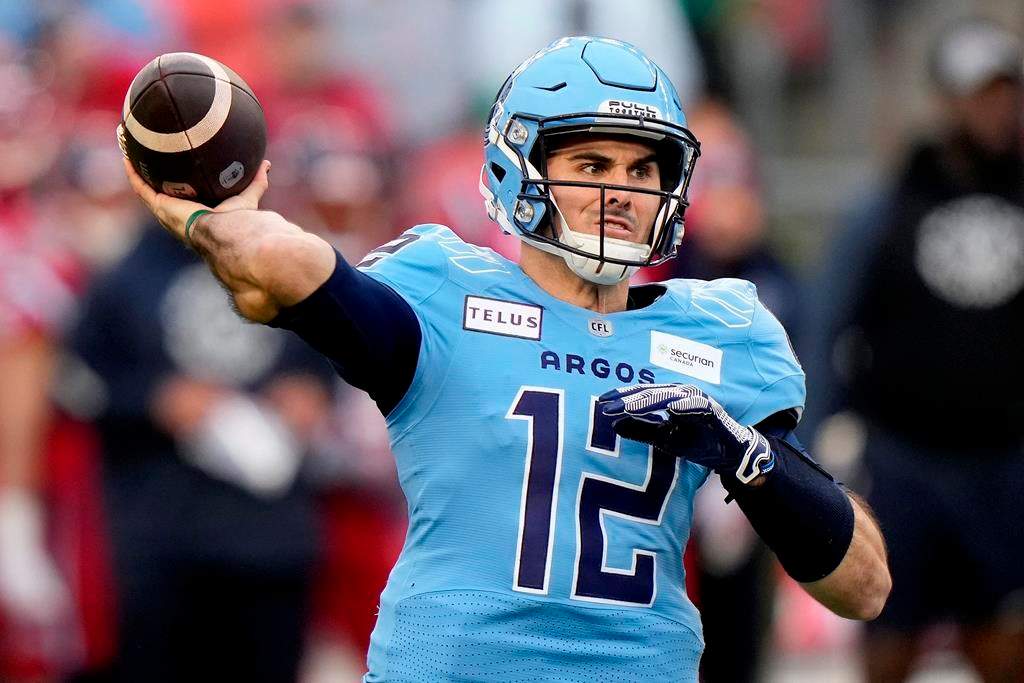 Toronto Argonauts quarterback Chad Kelly (12) makes the pass during first half CFL Eastern Division final football action against the Montreal Alouettes, in Toronto, Saturday, Nov. 11, 2023. The CFL says it's investigating after a lawsuit was issued by a former Toronto Argonauts strength-and-conditioning coach against the club for wrongful dismissal and quarterback Chad Kelly for alleged violations of the Ontario Human Rights Code. 