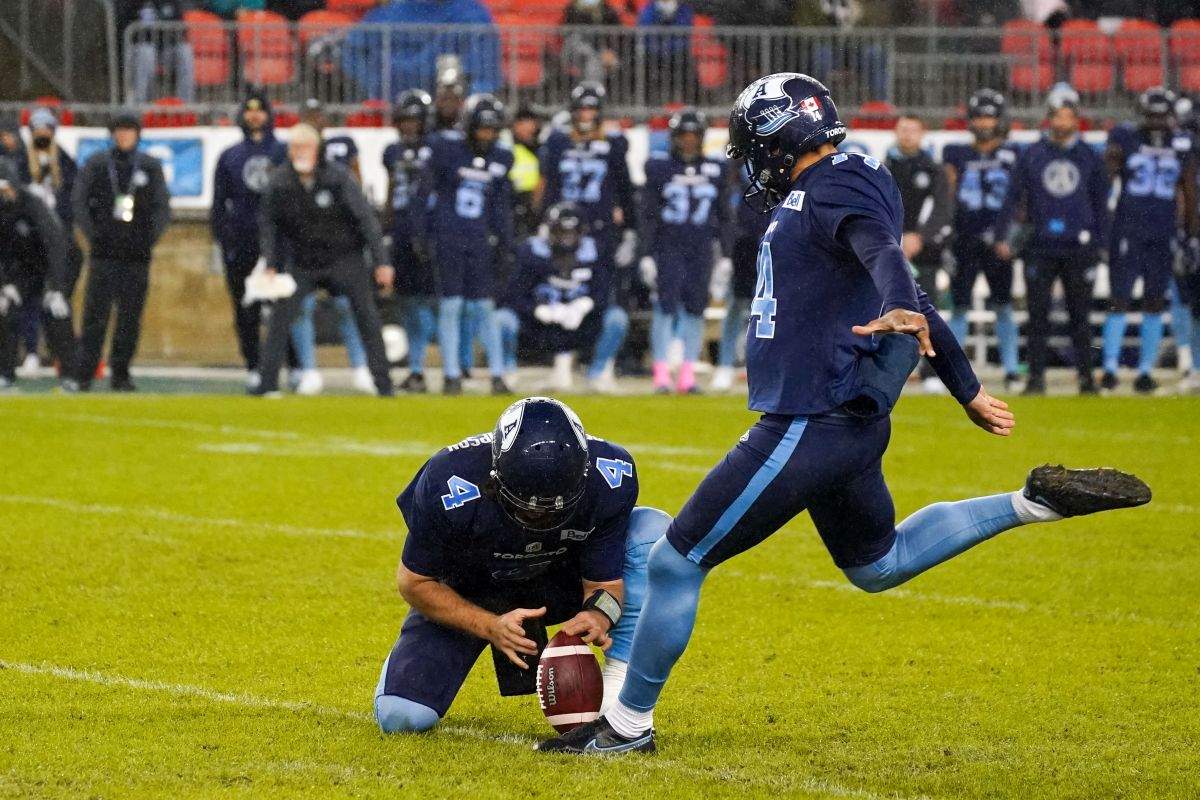 Toronto Argonauts kicker Boris Bede (14) kicks a field goal held by Toronto Argonauts quarterback McLeod Bethel-Thompson (4) during second half CFL action against the B.C. Lions in Toronto on Saturday, October 30, 2021.