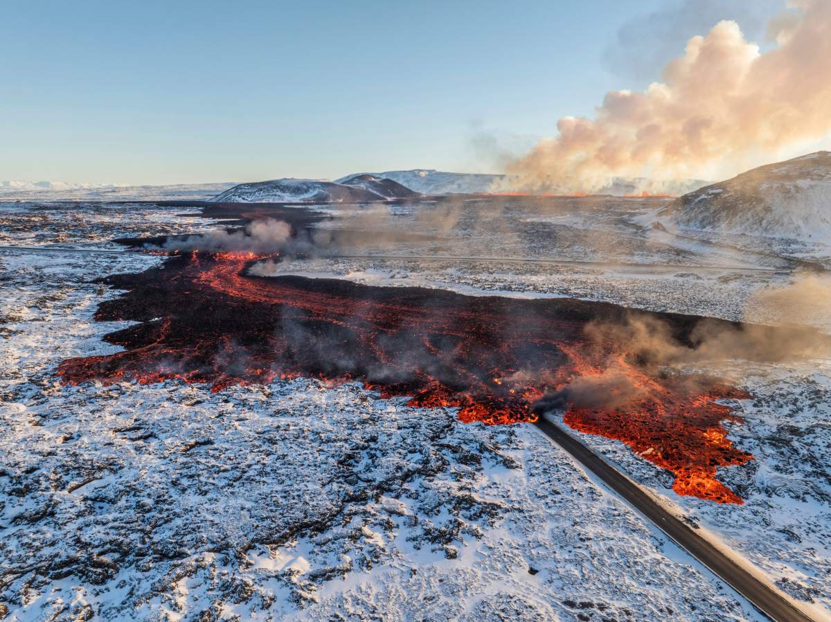 A view of lava crossing the main road to Grindavík and flowing on the road leading to the Blue Lagoon, in Grindavík, Iceland, Thursday, Feb. 8, 2024.