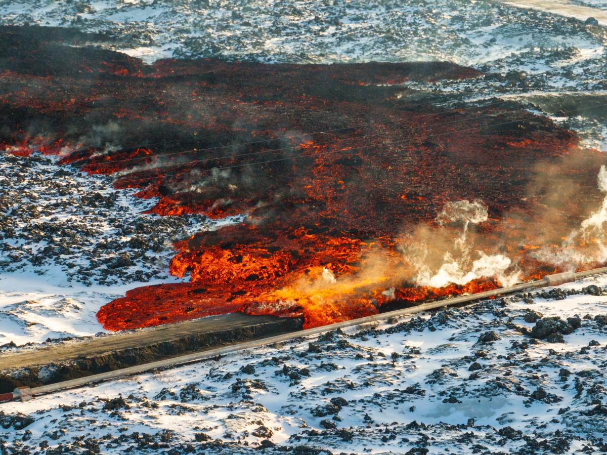 A view of lava hitting the hot water pipeline flowing on the road leading to the Blue Lagoon, in Grindavík, Iceland, Thursday, Feb. 8, 2024.