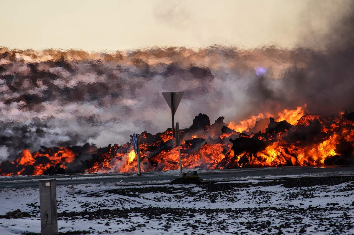 Lava reaches close to the road to Grindavík, near the exit for the blue lagoon, in Grindavík, Iceland, Thursday, Feb. 8, 2024.