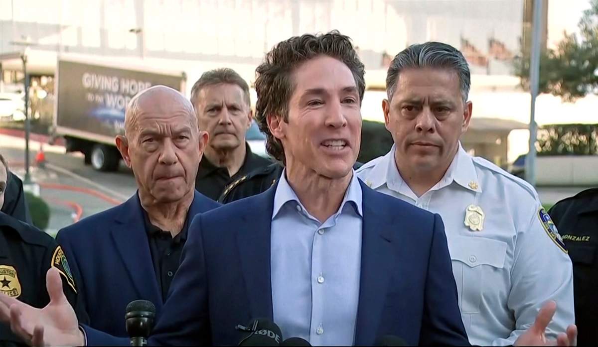 Pastor Joel Osteen speaks at a microphone.