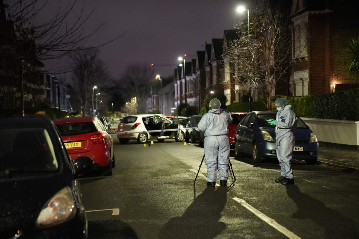 Police at the scene of an incident near Clapham Common, south London, after a suspected corrosive substance was thrown at a woman and her two young children.