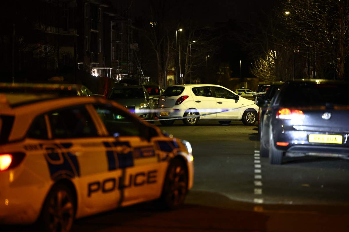 A car is seen behind police cordon after a suspected corrosive substance attack in south London on February 1, 2024.