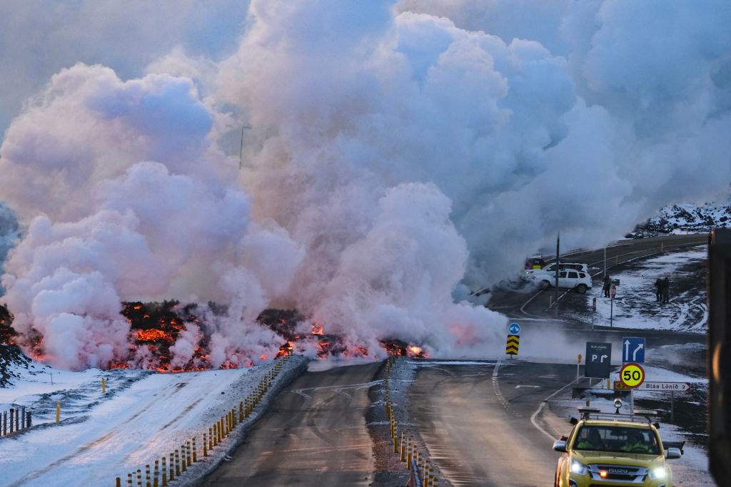 Molten lava is seen overflowing the road leading to the famous tourist destination "Blue Lagoon" near Grindavik, western Iceland on February 8, 2024.