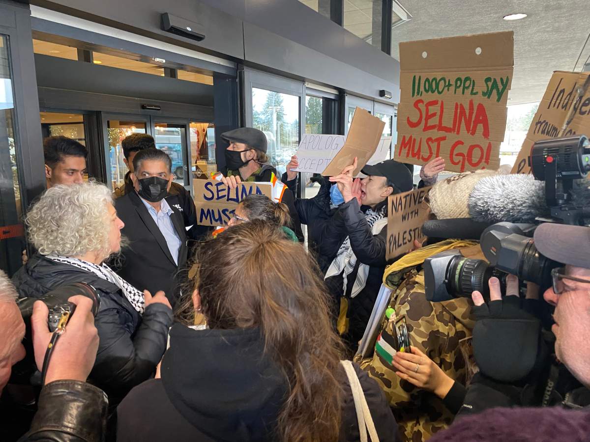 Dozens of people outside the NDP MLA retreat in Surrey Monday morning, demanding Selina Robinson resign.
