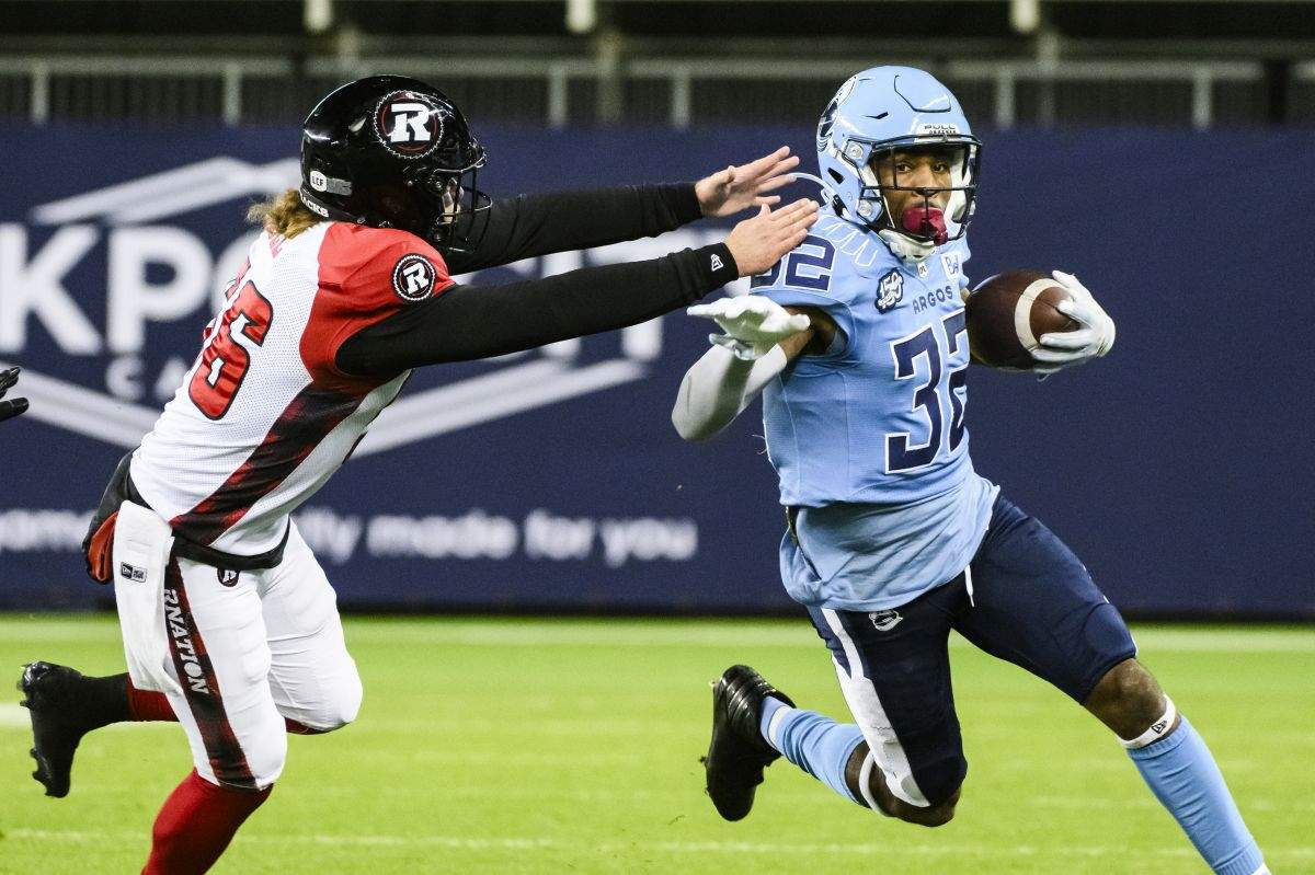 Toronto Argonauts running back Javon Leake (32) returns the ball while Ottawa Redblacks long snapper Tanner Doll (56) attempts to make the tackle, during first half CFL action, in Toronto, Saturday, Oct. 14, 2023.