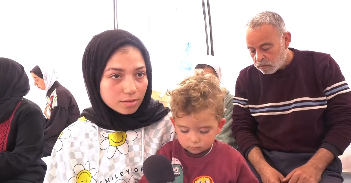 Lama Zaqoul with her and Nedal’s son in their family’s tent in Rafah.