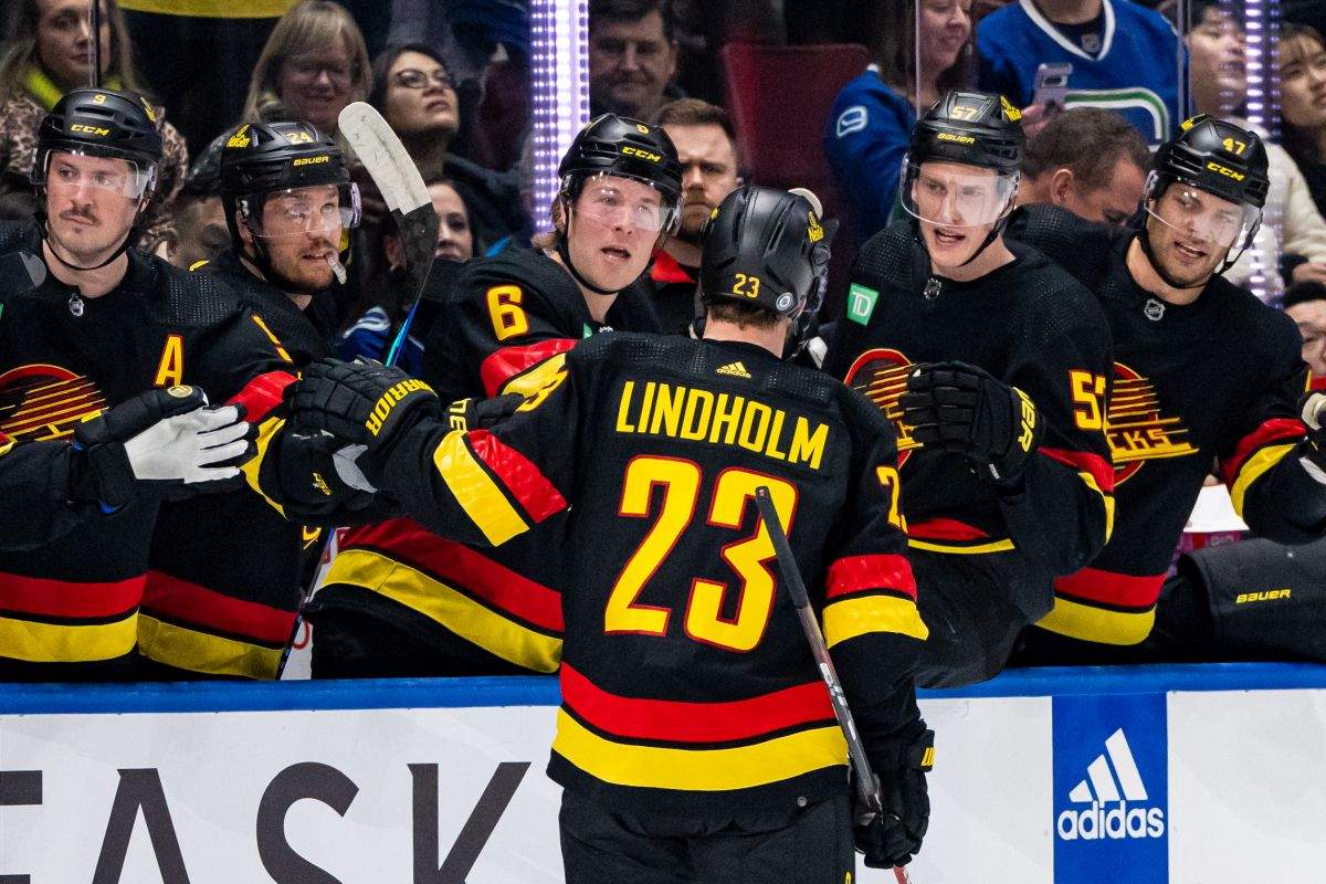 Vancouver Canucks' Elias Lindholm (23) celebrates his goal with his teammates during the first period of an NHL hockey game against the Detroit Red Wings, in Vancouver on Thursday, Feb. 15, 2024.