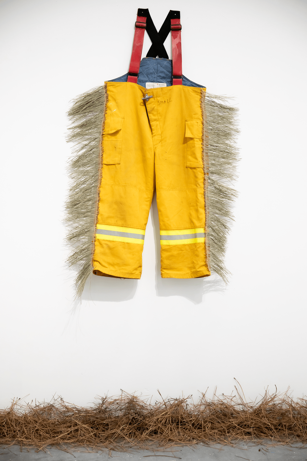 A pair of overalls hang