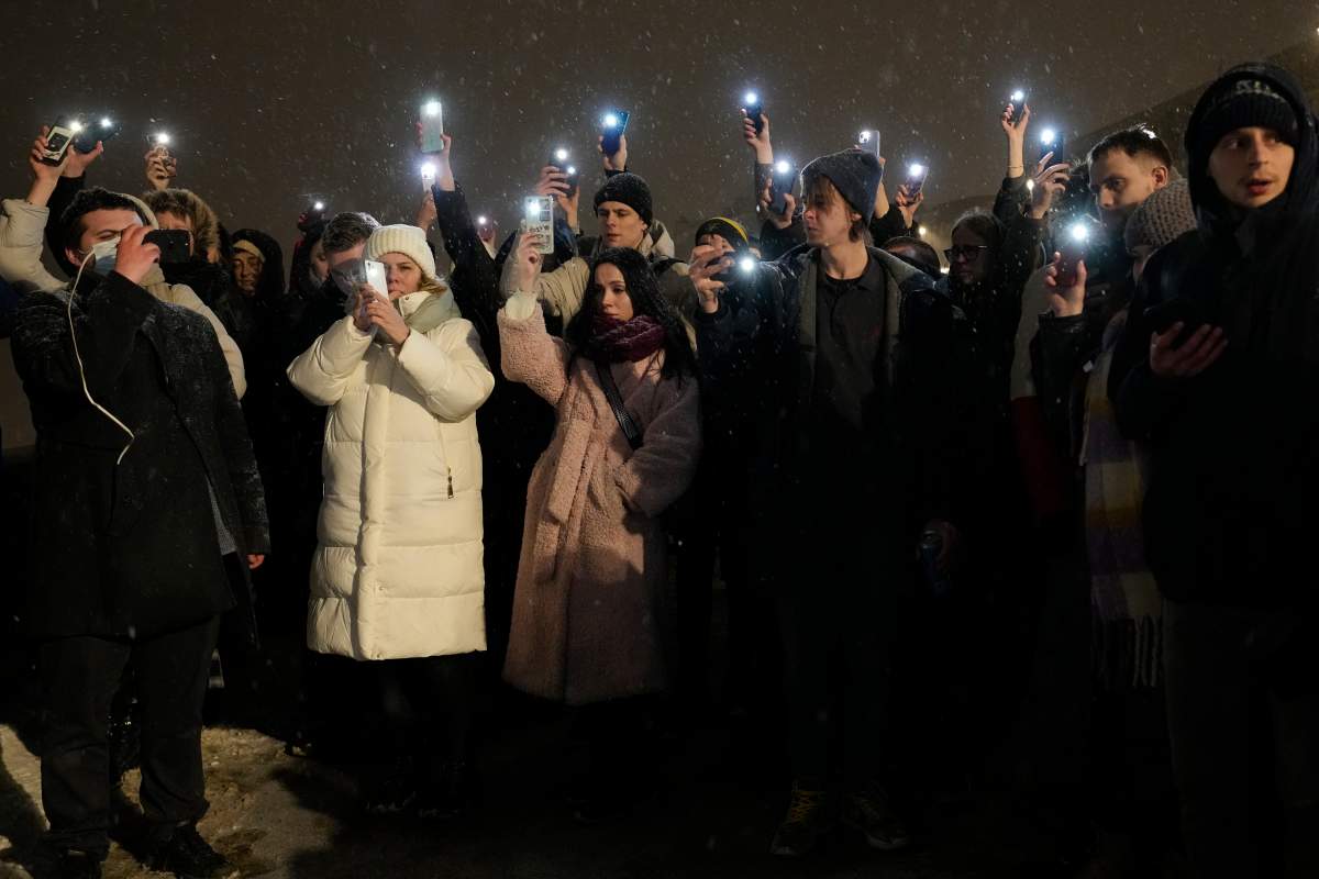People hold up their mobile phones with lights paying their last respect to Alexei Navalny at the Memorial to Victims of Political Repression in St. Petersburg, Russia on Friday, Feb. 16, 2024. Russian authorities say that Alexei Navalny, the fiercest foe of Russian President Vladimir Putin who crusaded against official corruption and staged massive anti-Kremlin protests, died in prison. He was 47. (AP Photo/Dmitri Lovetsky)