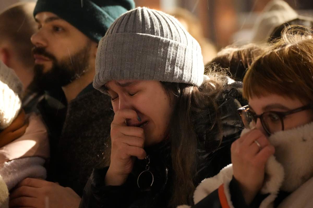 Youth react as they gather to lay flowers paying their last respect to Alexei Navalny at the Memorial to Victims of Political Repression in St. Petersburg, Russia on Friday, Feb. 16, 2024. Russian authorities say that Alexei Navalny, the fiercest foe of Russian President Vladimir Putin who crusaded against official corruption and staged massive anti-Kremlin protests, died in prison. He was 47. (AP Photo/Dmitri Lovetsky)