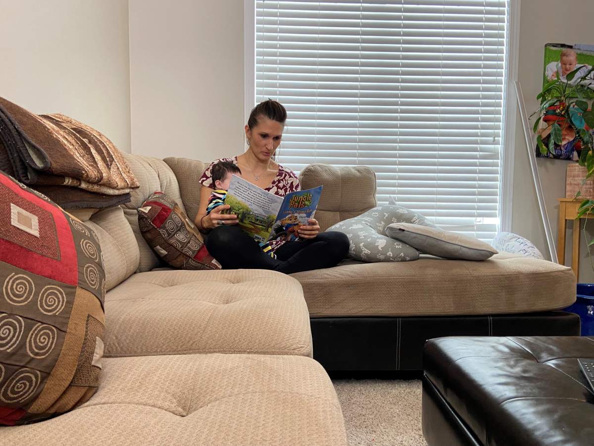 Daniella Antelo reading her book to her daughter.