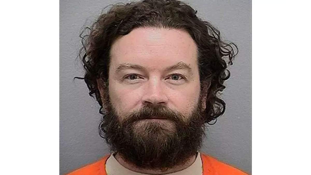 Danny Masterson's mugshot. He has curly hair and a large beard.