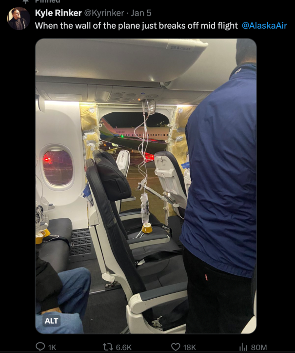 A screenshot of a tweet from Kyle Rinker. The text reads "When the wall of the plane just breaks off mid flight @AlaskaAir." The accompanying photo is from inside the plane's cabin, where there is a door-shaped hole in the wall, and visible tarmac beyond. Yellow insulation is poking out around the hole.