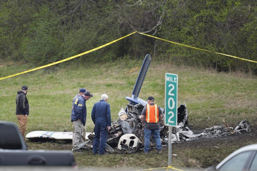 Investigators look over a small plane crash alongside eastbound Interstate 40 at mile marker 202 on Tuesday, March 5, 2024, in Nashville, Tenn. U.S. authorities continue to investigate a plane crash in Tennessee that killed five Canadians.