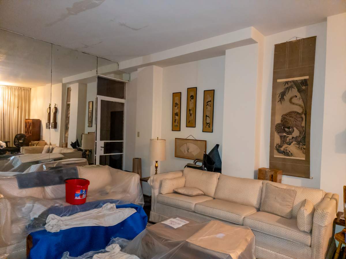 Clear plastic sheets cover most of Stuart's furniture to prevent damage from potential leaks.