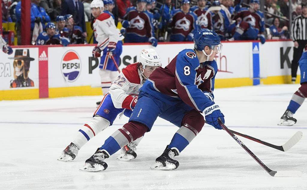 Colorado Avalanche defenceman Cale Makar, front, collects the puck as Montreal Canadiens right wing Cole Caufield pursues in the second period of an NHL hockey game on March 26, 2024, in Denver.