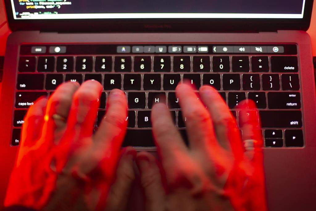 A man uses a computer keyboard in Toronto in this Sunday, Oct. 9, 2023 photo illustration. A town in Ontario's Muskoka region has shared more details about a cybersecurity incident earlier this month. THE CANADIAN PRESS/Graeme Roy.