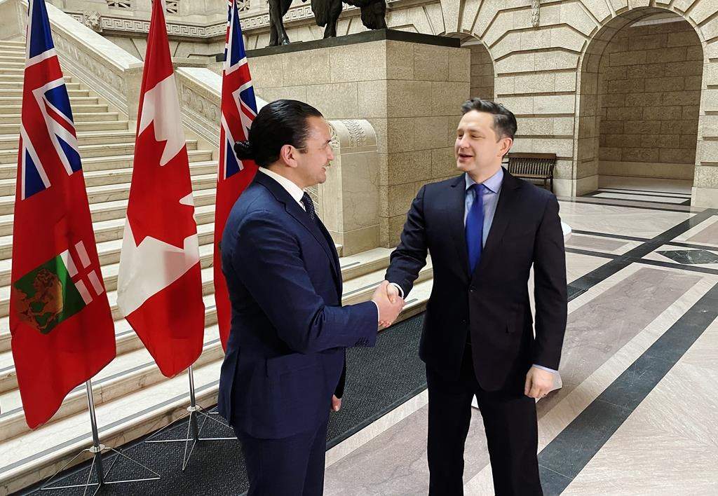 Conservative Leader Pierre Poilievre, right, shakes hands with Manitoba Premier Wab Kinew prior to a meeting at the legislature in Winnipeg on Thursday, March 28, 2024. THE CANADIAN PRESS/Steve Lambert.