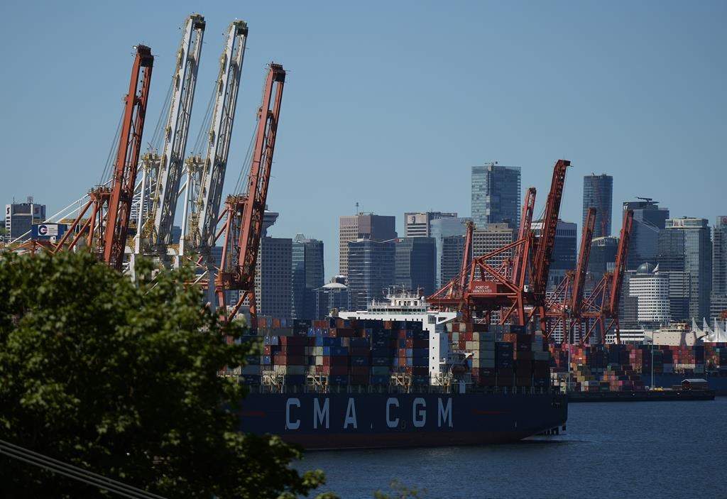 Gantry cranes are shown as a container ship is docked at port in Vancouver, on Wednesday, July 19, 2023.