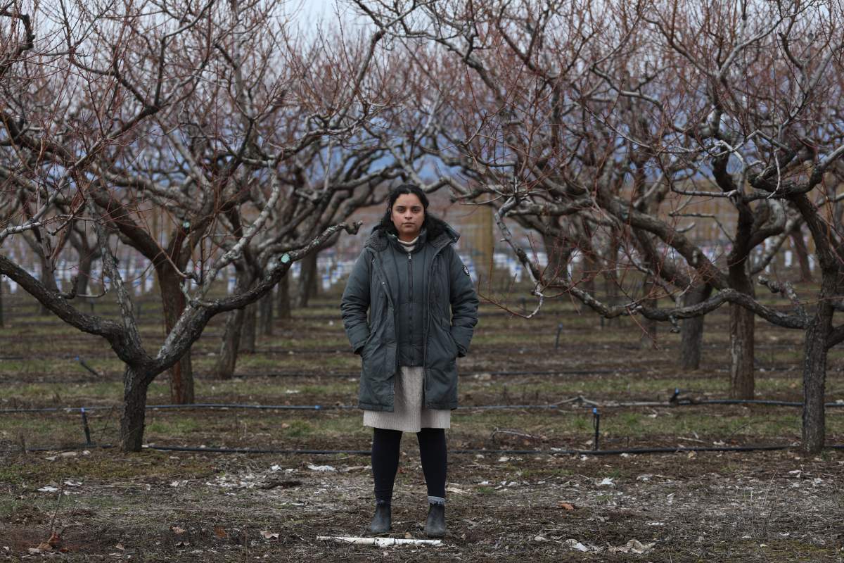 Jennifer Deol, the co-owner of There and Back Again Farms, stands near the farm’s peach orchard in Kelowna, B.C., on Tuesday, March 5, 2024. B.C. farmers are predicting at least a 90 per cent loss of this summer's harvest of fruit including peaches, apricots and nectarines.